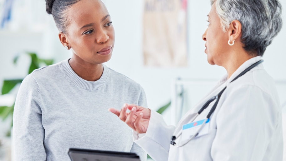 Provider discussing clinical trial options with a patient who suffers from gastroenterology disorder