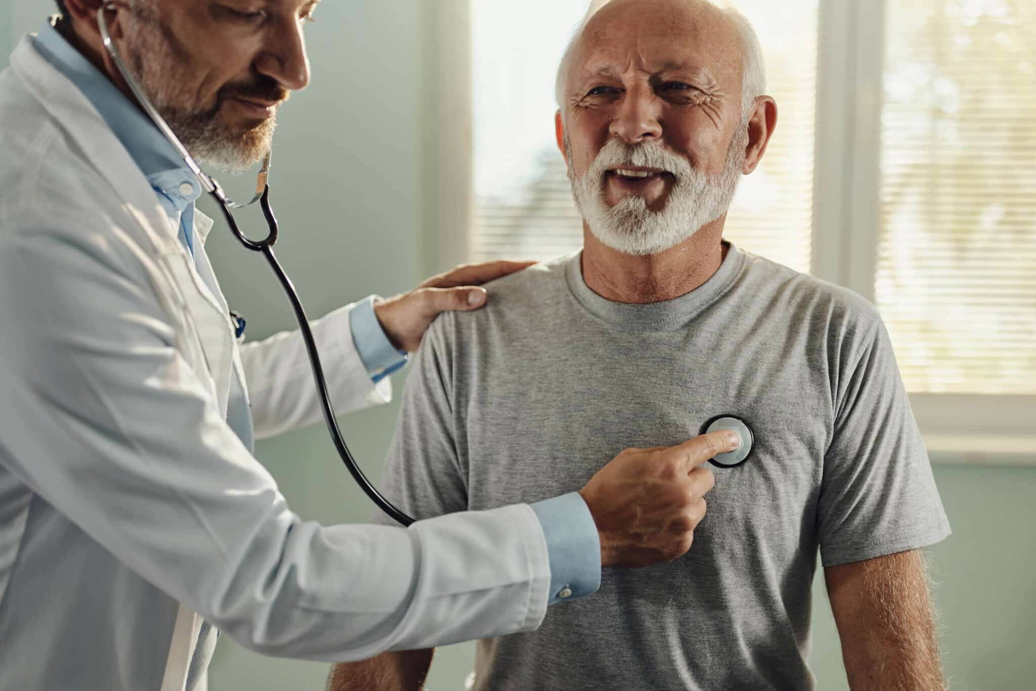 Provider listening to a patient's heart with a stethoscope