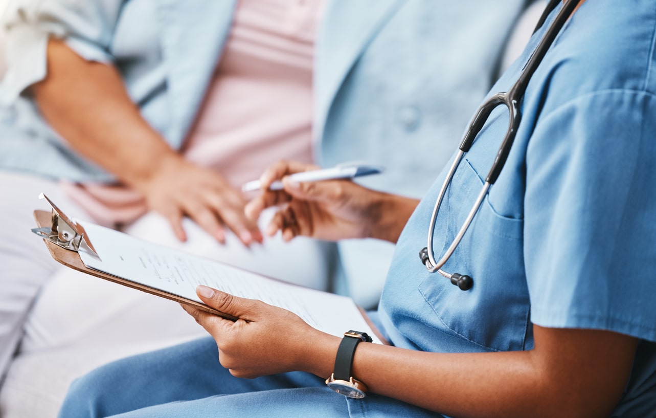 Provider reviewing medical documents with a trial participant