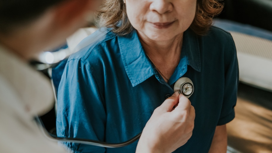 Provider using a stethoscope to listen to a patient's lungs