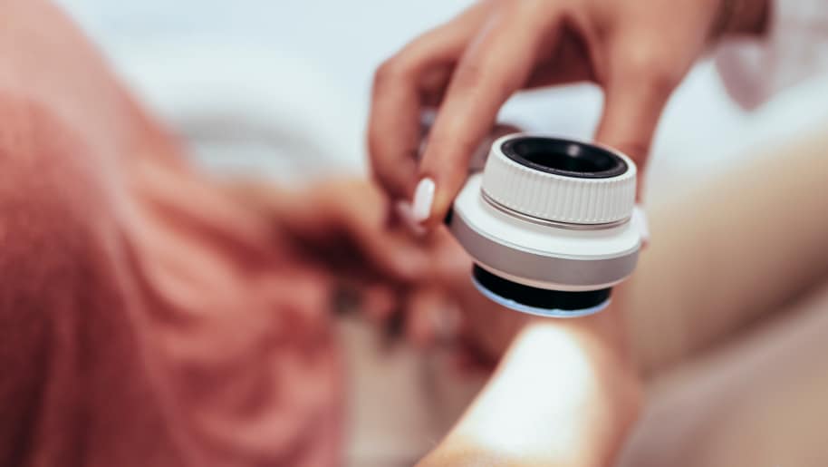 Dermatologist using dermatoscope to look at a patient's skin