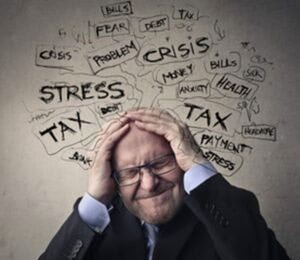 pictured: a stressed person holds their head, surrounded by stressful words like "tax" and "crisis"