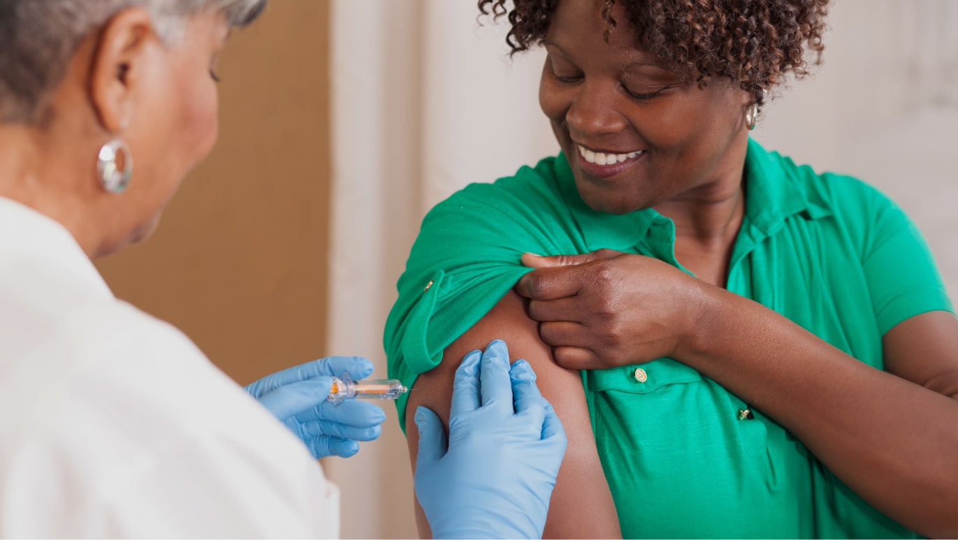 Provider giving a vaccine to a clinical trial participant